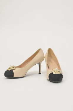 Cream leather and grosgrain round-toe camellia platform pumps with contrasting toe caps
