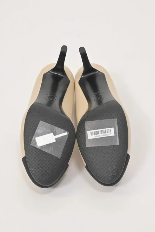 Cream leather and grosgrain round-toe camellia platform pumps with contrasting toe caps