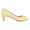 Cream patent leather almond-toe court pumps with signature pebble vamp buckle