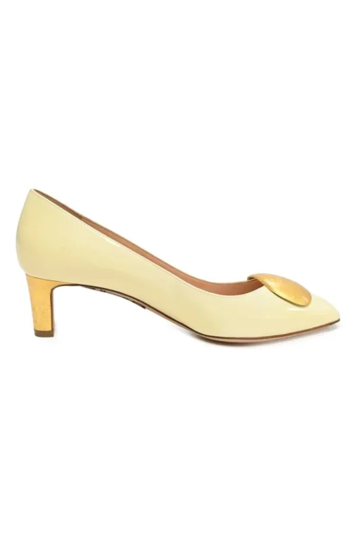 Cream patent leather almond-toe court pumps with signature pebble vamp buckle
