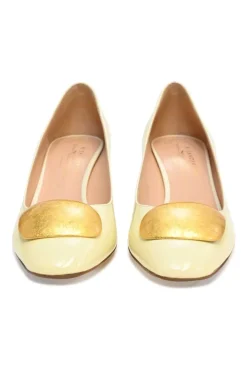 Cream patent leather almond-toe court pumps with signature pebble vamp buckle