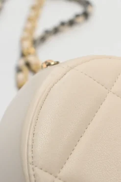 Cream quilted goatskin 19 round clutch with chain with mixed-metal hardware
