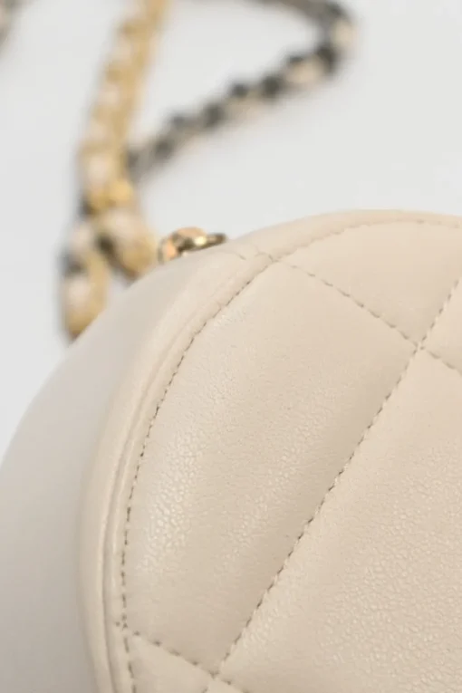 Cream quilted goatskin 19 round clutch with chain with mixed-metal hardware