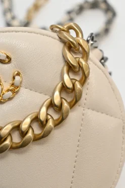 Cream quilted goatskin 19 round clutch with chain with mixed-metal hardware