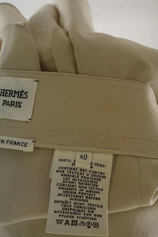 Cream silk asymmetric apron-style wrap-front A-line skirt with pull tab fastening at side