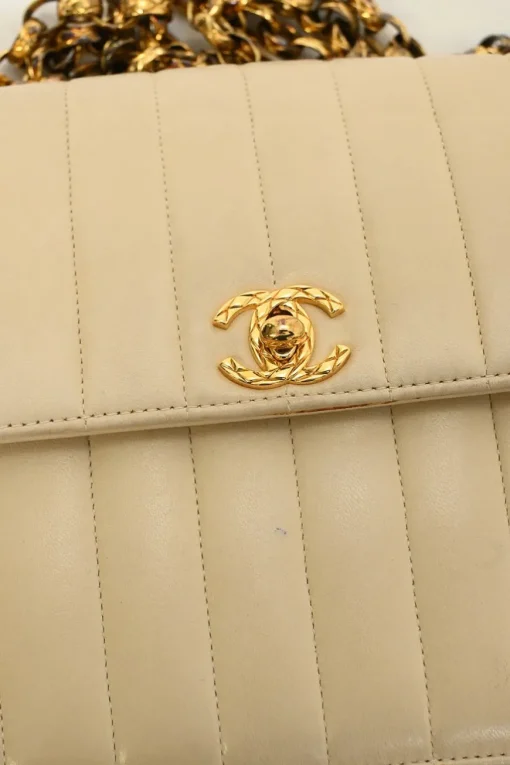 Cream vertical quilted lambskin leather Mademoiselle flap bag with gold-plated hardware