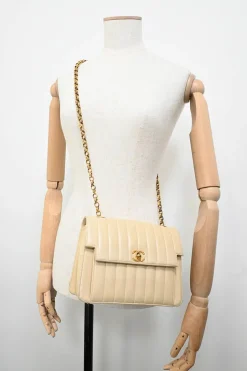 Cream vertical quilted lambskin leather Mademoiselle flap bag with gold-plated hardware