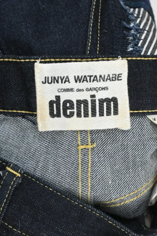 Dark indigo cotton denim straight-leg boro jeans featuring mixed-media patch appliqué