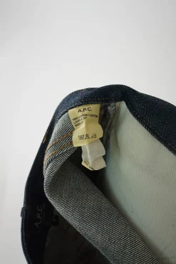 Dark indigo cotton denim low-rise five-pocket mini skirt with belt loop waistband