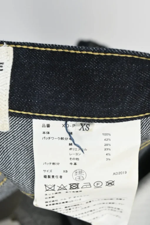 Dark indigo cotton denim straight-leg boro jeans featuring mixed-media patch appliqué