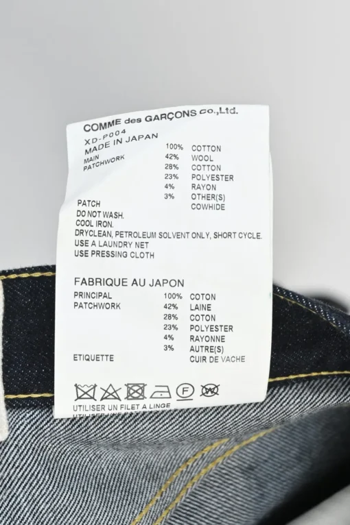 Dark indigo cotton denim straight-leg boro jeans featuring mixed-media patch appliqué