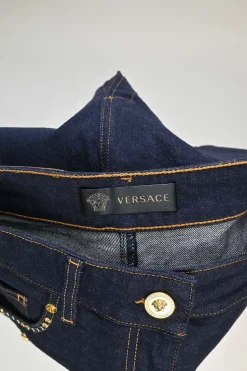 Dark indigo embellished cotton-blend denim Medusa rivet and shank button pencil skirt