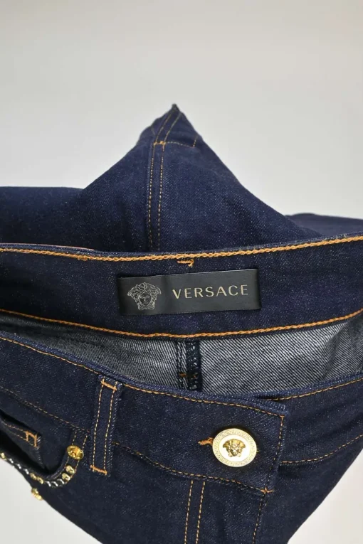 Dark indigo embellished cotton-blend denim Medusa rivet and shank button pencil skirt