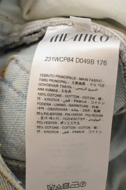 Dirt wash indigo cotton denim pull-high rise bow-leg cargo jeans with tab cuffs