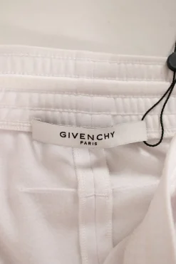 Givenchy white sports skirt with elasticated waist band, drawstring, side pockets with zips, and branding in mirror letters on sides