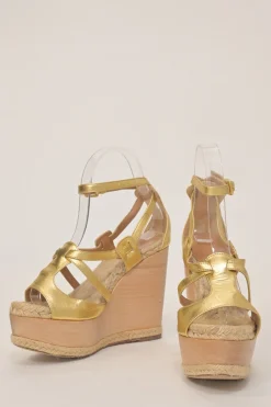 Gold foiled lambskin, raffia, and wood cutout platform wedge sandals with buckle strap fastening