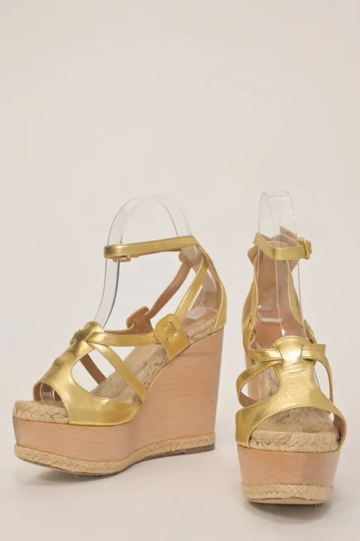 Gold foiled lambskin, raffia, and wood cutout platform wedge sandals with buckle strap fastening