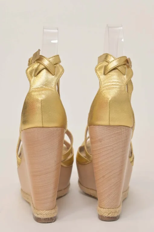 Gold foiled lambskin, raffia, and wood cutout platform wedge sandals with buckle strap fastening