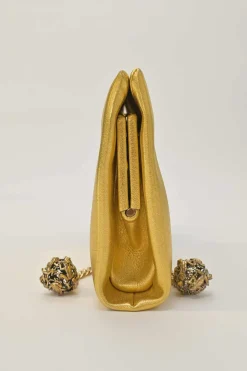 Gold foiled leather frog tassel clutch with gold-tone metallic hardware