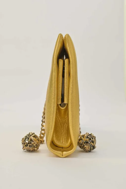 Gold foiled leather frog tassel clutch with gold-tone metallic hardware