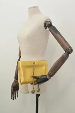 Gold foiled leather frog tassel clutch with gold-tone metallic hardware
