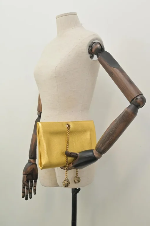 Gold foiled leather frog tassel clutch with gold-tone metallic hardware