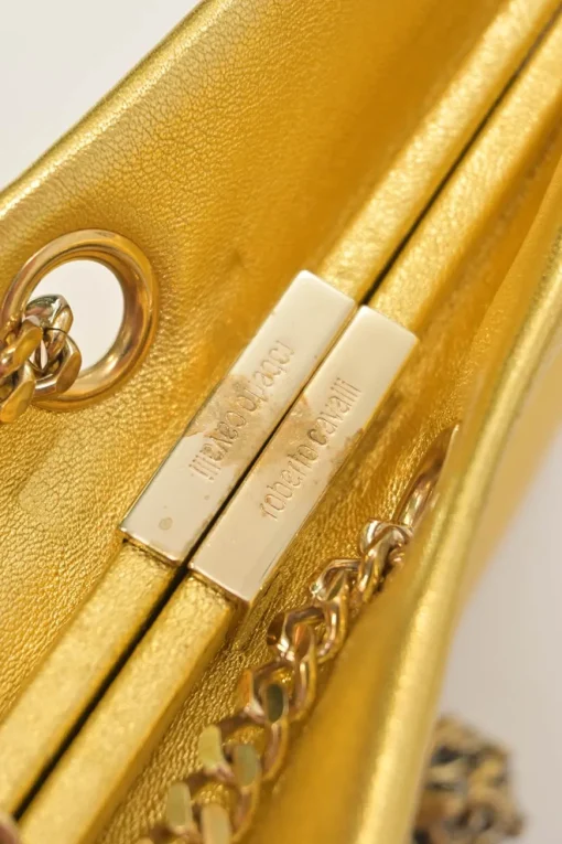 Gold foiled leather frog tassel clutch with gold-tone metallic hardware