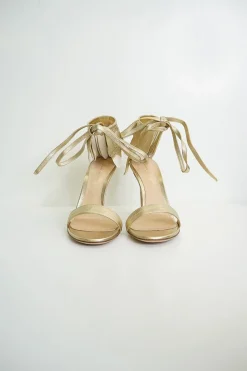 Gold leather ankle tie heeled sandals and feather trim
