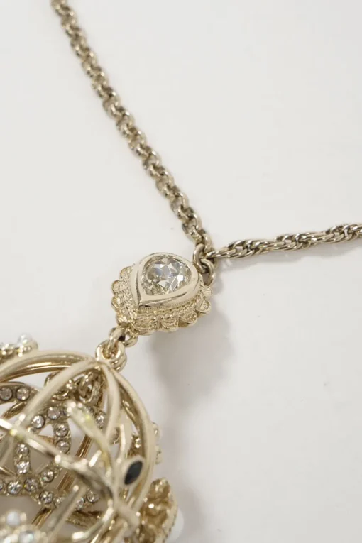 Gold metal with crystals and white resin pearls logo bird cage necklace