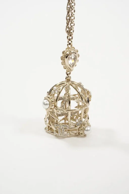 Gold metal with crystals and white resin pearls logo bird cage necklace