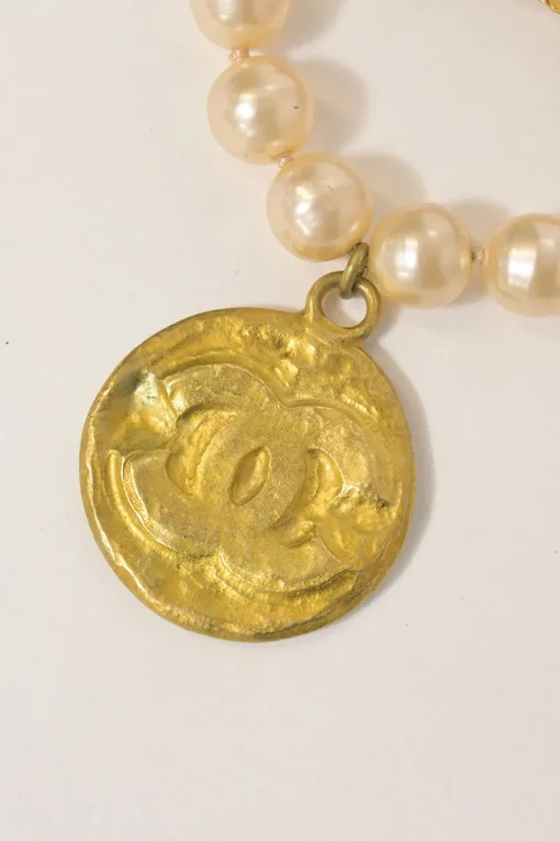 Gold-finish hammered metal, leather, and resin faux pearl Coco Mark medallion brooch