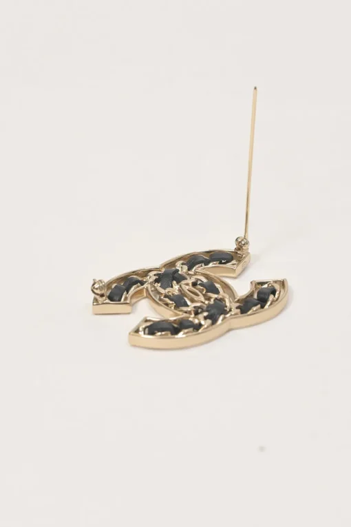 Gold-finish metal and leather Coco Mark brooch