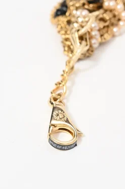 Gold-finish metal and resin faux pearl charm bib necklace with lobster clasp closure
