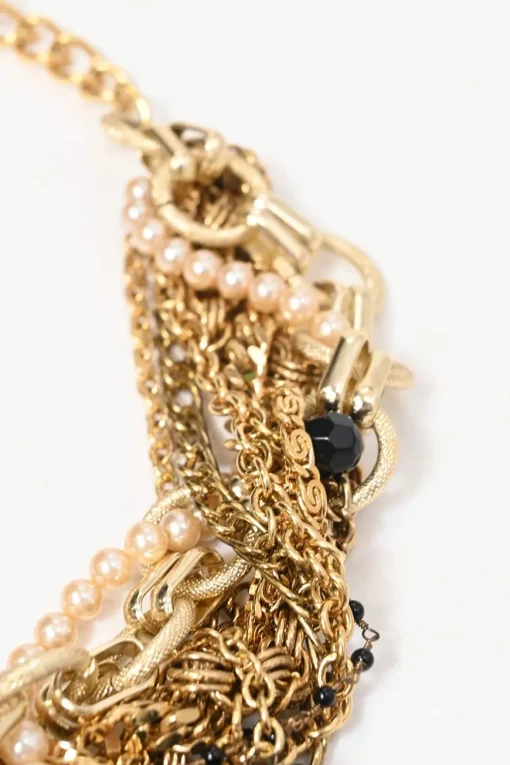 Gold-finish metal and resin faux pearl charm bib necklace with lobster clasp closure