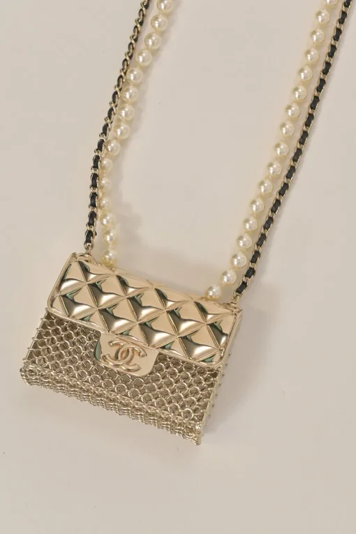Gold-finish metal, resin, and leather micro flap bag crossbody bag necklace with faux pear and chainlink strap