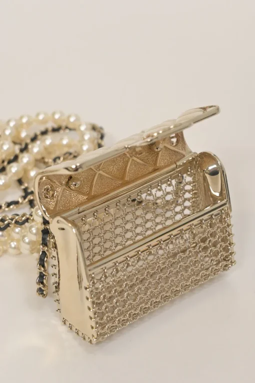 Gold-finish metal, resin, and leather micro flap bag crossbody bag necklace with faux pear and chainlink strap