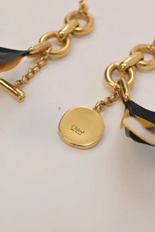 Gold-tone metallic feather-trimmed chainlink post drop earrings with horse medallion charm