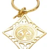 Gold-tone metallic stamped key ring featuring abstract motif