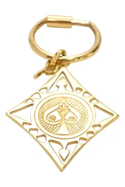 Gold-tone metallic stamped key ring featuring abstract motif