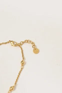 Gold-tone permabrass Petit CD charm bracelet with lobster clasp closure