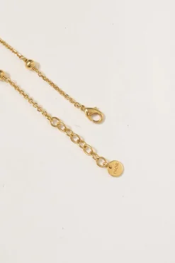 Gold-tone permabrass Petit CD charm bracelet with lobster clasp closure