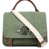 Green and brown leather top satchel bag with silver metal detail on the fabric flap and detachable fabric shoulder strap.
