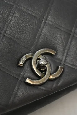 Grey embossed matelassé calfskin crossbody flap bag with gunmetal Coco Mark turnlock closure