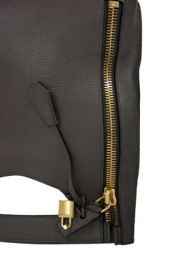 Grey leather handbag with detachable shoulder strap and large gold zipper detail