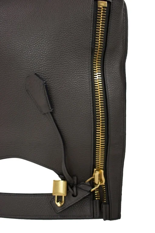 Grey leather handbag with detachable shoulder strap and large gold zipper detail
