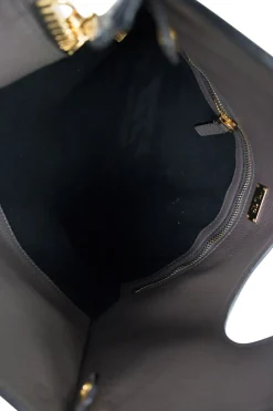 Grey leather handbag with detachable shoulder strap and large gold zipper detail