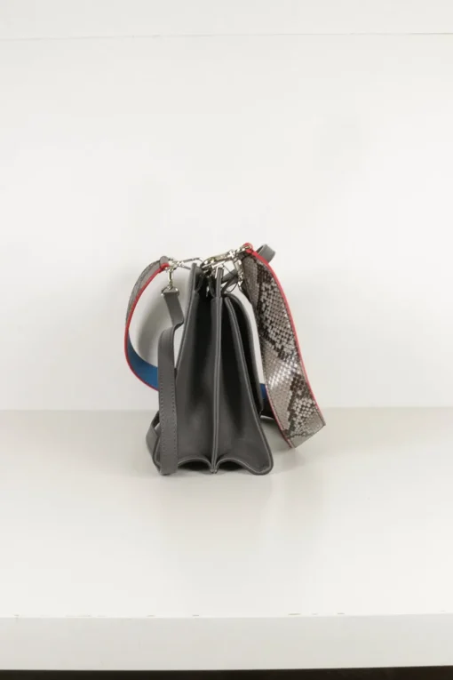 Grey pebbled leather bag with front flap, magnetic clasp and short top handle.