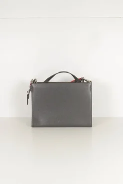 Grey pebbled leather bag with front flap, magnetic clasp and short top handle.