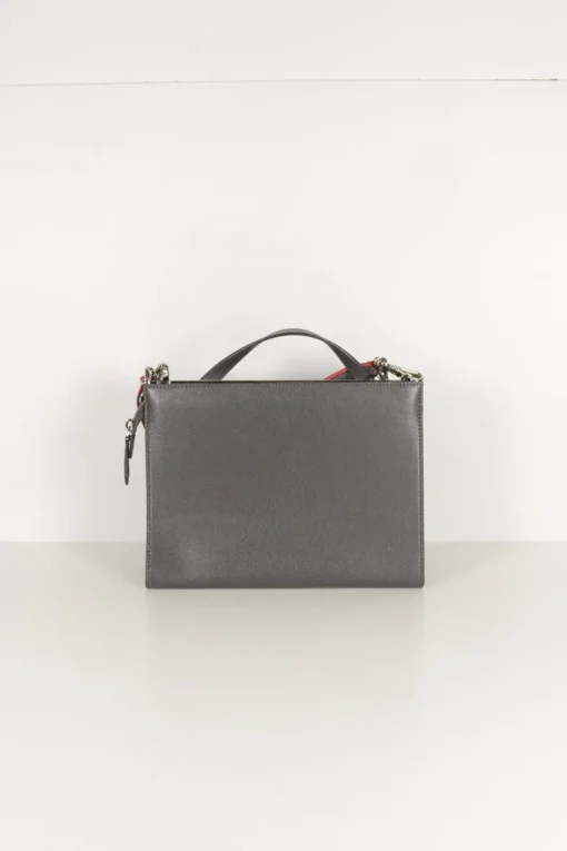 Grey pebbled leather bag with front flap, magnetic clasp and short top handle.