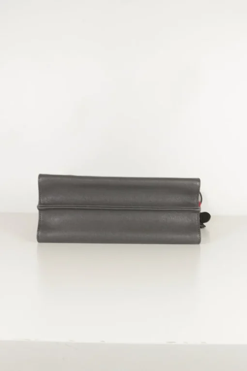 Grey pebbled leather bag with front flap, magnetic clasp and short top handle.